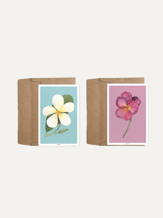 Two floral greeting cards with brown paper envelopes on a white background